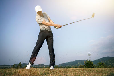 Man playing with ball against sky