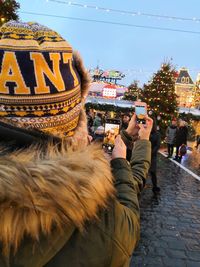 People photographing on street in city