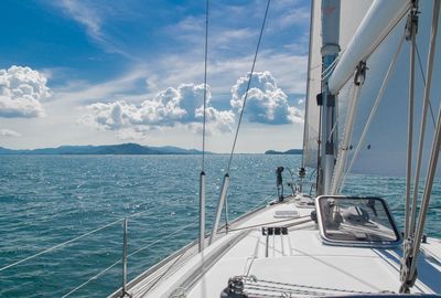 Sailboat sailing on sea against sky