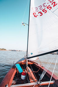 Sailboat sailing in sea against sky