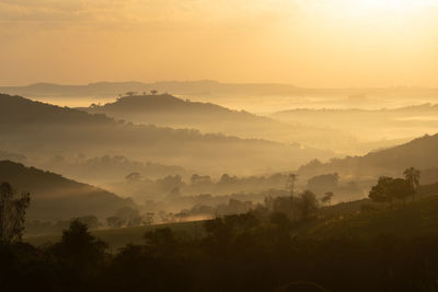 Scenic view of mountains against sky during sunrise