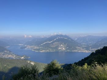 High angle view of plants and mountains against clear blue sky