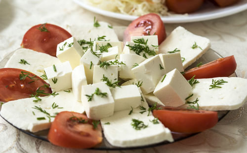 Close-up of feta cheese with tomatoes served in plate on table
