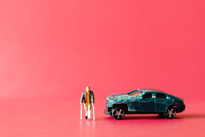 Toy car against red background