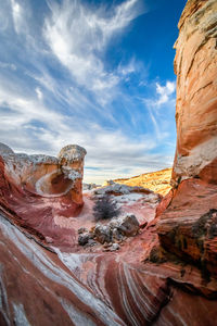 Rock formations against cloudy sky