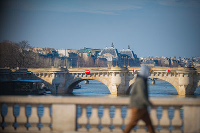 Bridge over river with buildings in background