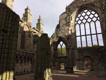 Exterior of temple against sky seen through window