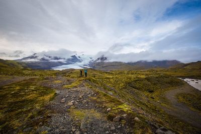 Scenic view of landscape against cloudy sky