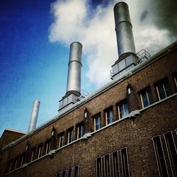 Low angle view of factory against sky