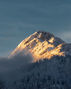 Scenic view of snow covered mountains against sky