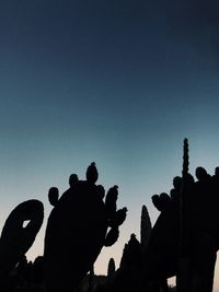 Silhouette people against clear blue sky