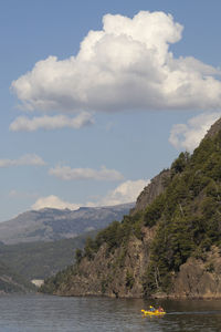 Scenic view of sea and mountains against sky