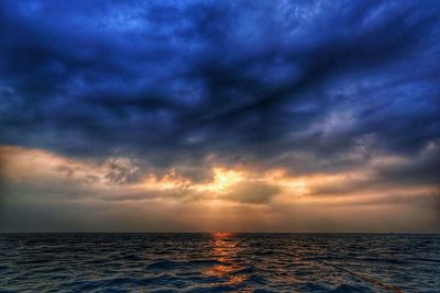 Scenic view of sea against sky at sunset