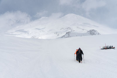 Rear view of man skiing on snow covered mountain