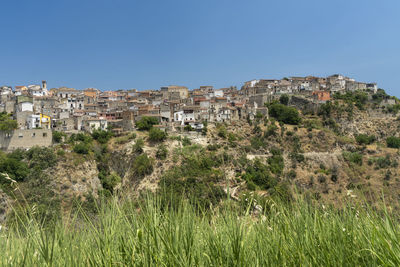 Panoramic shot of buildings against clear blue sky