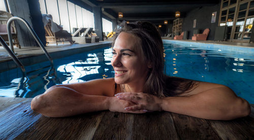 Smiling woman relaxing in swimming pool