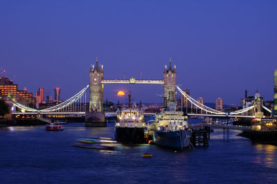 View of bridge over river at night