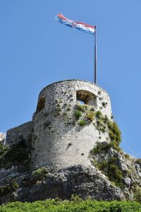 Low angle view of historical building against blue sky