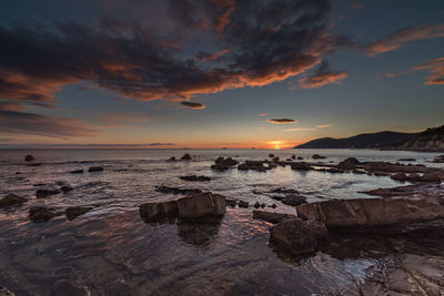 The warm lights of sunset over the winter sea.