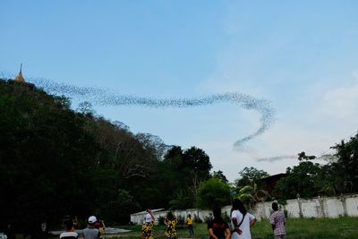 Group of people on land against sky