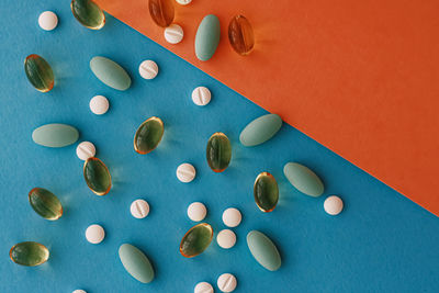 Directly above shot of pills against blue background