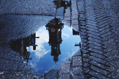 Reflection of building in puddle