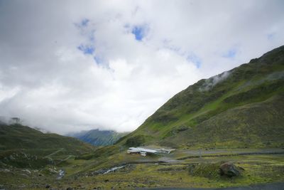 Scenic view of mountains against cloudy sky