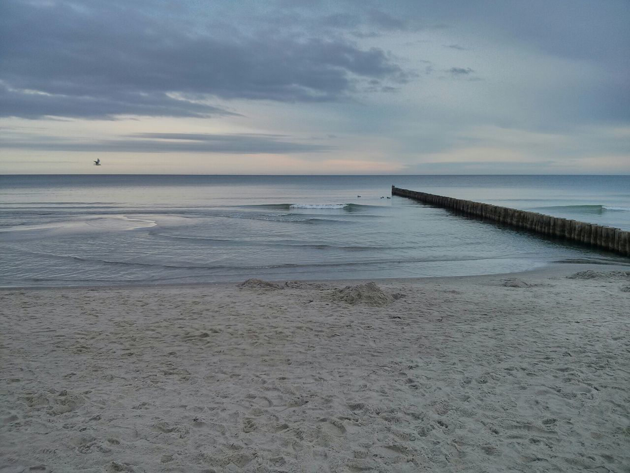 sea, horizon over water, water, sky, beach, tranquil scene, scenics, tranquility, shore, cloud - sky, beauty in nature, nature, sand, idyllic, cloud, pier, cloudy, calm, outdoors, incidental people