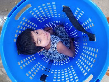 Portrait of girl sitting in basket