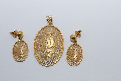 Close-up of gold colored pencils against white background