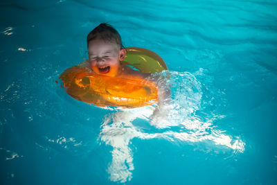 High angle view of boy swimming in pool