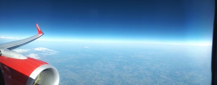 Cropped image of airplane flying over sea