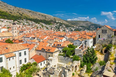 High angle view of houses in town against sky