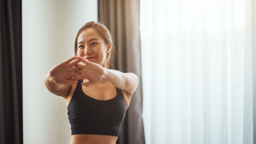 Young woman exercising in gym