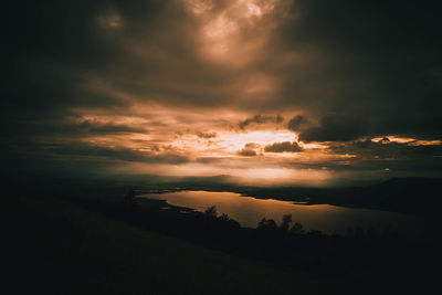 Scenic view of dramatic sky over sea during sunset