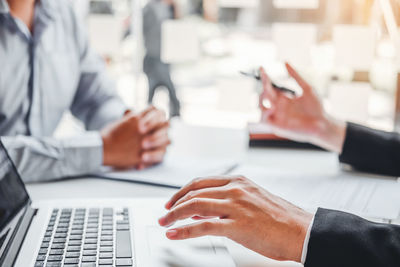 Midsection of man using laptop