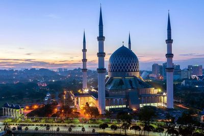 View of illuminated city at sunset