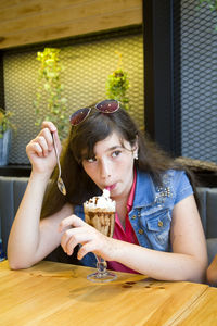 Young woman looking away while having dessert at cafe