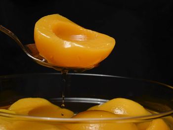 Close-up of yellow fruit against black background