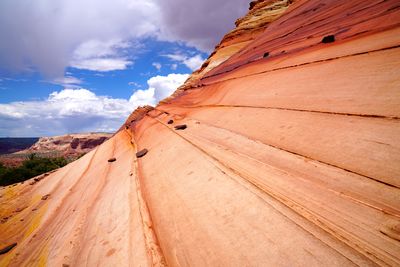 Low angle view of land against cloudy sky