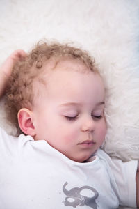 Close-up of baby boy sleeping on bed