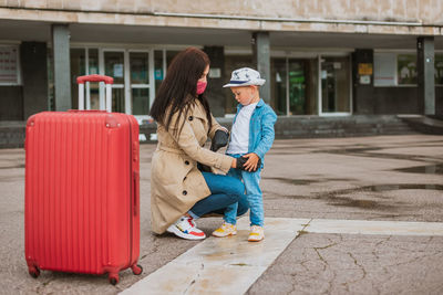 Full length of mother and girl wearing hat