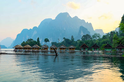 Scenic view of lake and buildings against sky