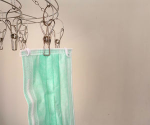 Close-up of clothes hanging on rope against wall