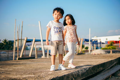 Full length of boys standing outdoors