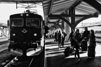 People waiting at railroad station platform