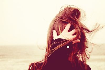 Woman looking at sea against sky