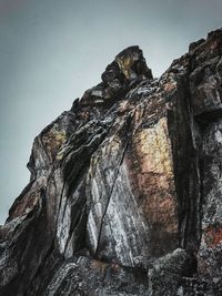Low angle view of rock formation against sky