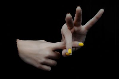 Close-up of human hand over black background