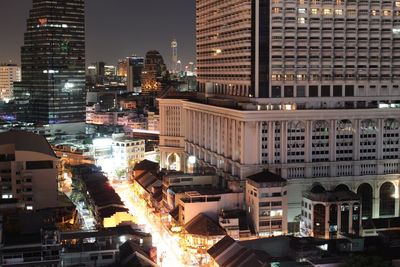 View of skyscrapers in city at night